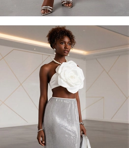Close-up of elegant 3D floral appliqué on white strapless top for party fashion