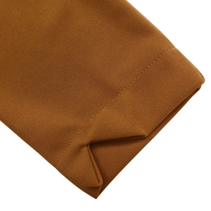 Detailed close-up of dark brown long sleeve cuff with high-quality stitching and fabric texture