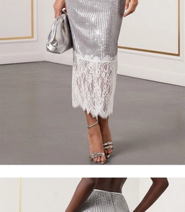 Detail of silver sequin skirt featuring delicate white floral lace hem for party wear