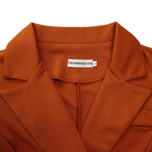 Detail of caramel notched lapel collar with neat stitching and METAMORPHOSIS GIRL tag