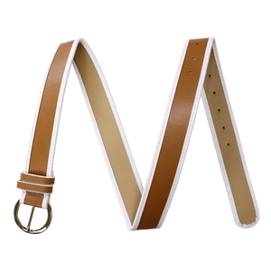 Detail of dark brown faux leather belt with white edges and golden round pin buckle