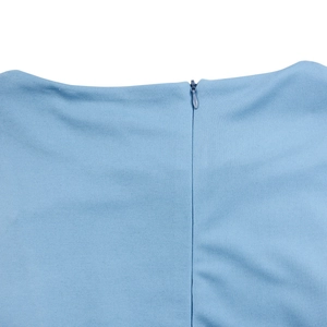 Detail shot of invisible zipper closure on light blue dress with textured fabric surface