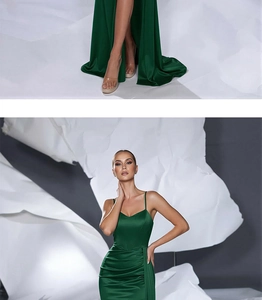 Detail of emerald green satin dress featuring pleated waist and high side slit