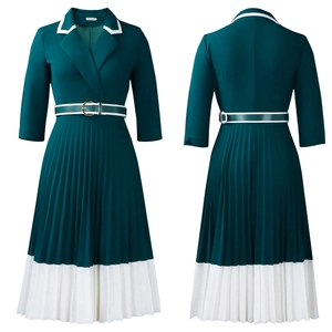 Detailed view of dark green A-line dress with white pleated hem and belted waistline