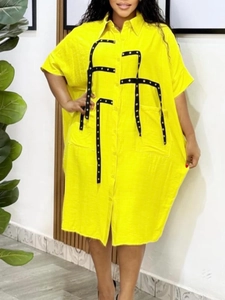 Bright yellow oversized cotton shirt dress with geometric black trim and buttons