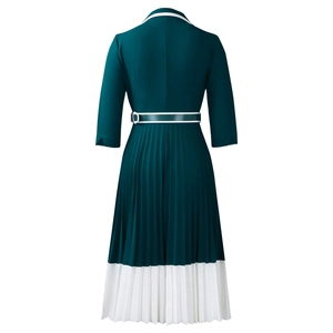 Detail view of the pleated dark green dress back with contrast white hem and waist belt