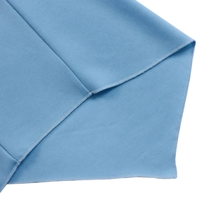 Detail view showing professional stitching and textured fabric on light blue dress