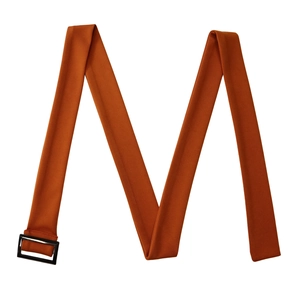 Detail of caramel orange woven fabric belt with a sleek black rectangular buckle