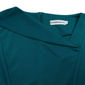 Detail view of teal dress showing asymmetrical neckline, ribbed texture and back zipper