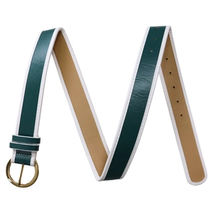 Detail of green leather belt featuring vintage gold circular buckle and white edge stitching