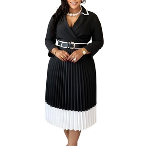 Detail of contrast lapel collar and pleated skirt design on monochrome midi dress