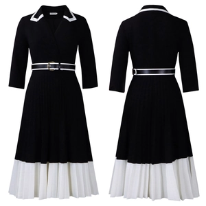 Detail of black and white colorblock dress with pleated hem and gold buckle waist belt