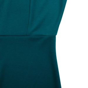 Detailed close-up showing the professional stitching and teal knit texture of the dress