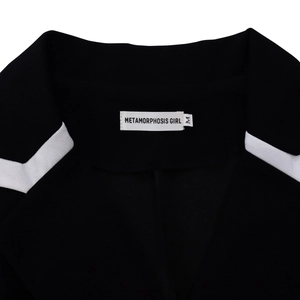 Detail view of the black jacket neckline featuring a white branded tag and size M label