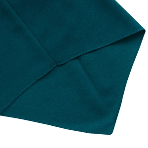Close-up of high-quality overlock stitching and fabric texture on dark green dress hem