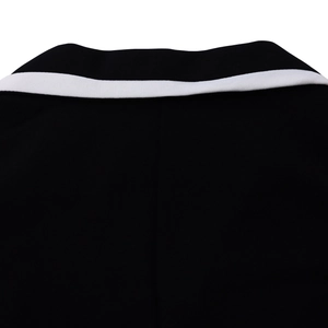 Close-up of contrast color block neckline and fabric texture on a monochrome A-line dress