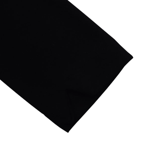 Detail of sleeve cuff and hem stitching on black A-line long sleeve dress