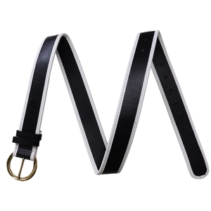 Detail of black leather belt with white contrast stitching and round gold metal buckle
