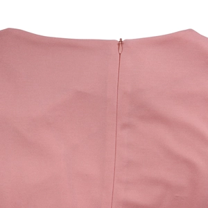 Detail of pink high-waist dress showing seamless invisible back zipper and smooth fabric