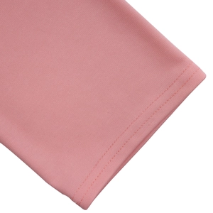 Detailed view of pink knitted fabric featuring professional double-needle stitching hem