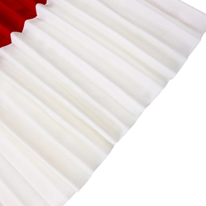 Detailed view of two-tone pleated fabric showing red and white color blocking