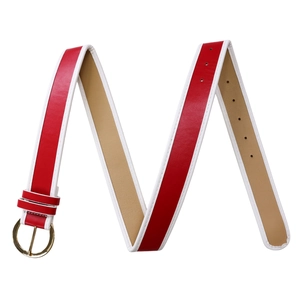 Detail view of a red leather belt with white edges and a golden circular buckle