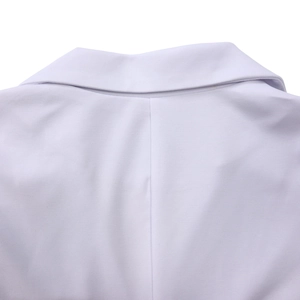 Detailed close-up of white blazer back seam and premium fabric texture detail