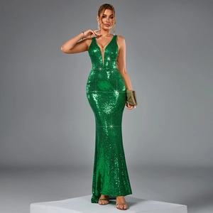 Detailed close-up of emerald green sequins and fishtail hem on backless evening dress