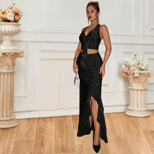 Elegant black two-piece halter neck top and side slit maxi skirt set with ruffles
