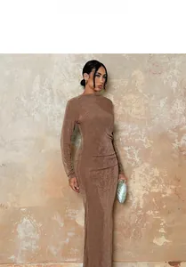 Detailed view of brown long sleeve maxi dress with ruching and vintage pearlescent clutch