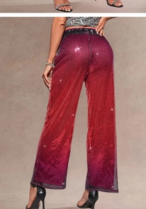 Close-up of sparkling purple and red sequin fabric on high waist wide leg party pants