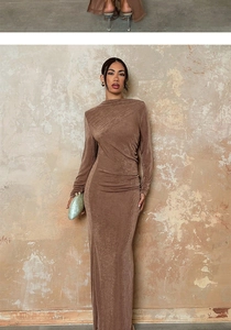 Detailed view of brown long sleeve evening dress featuring ruched waist and textured fabric