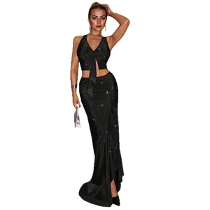 Elegant black sequin two-piece set featuring a halter crop top and high waist slit maxi skirt