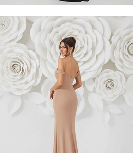 Back view of champagne sequin backless evening gown with a fishtail hem and slim fit