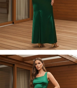Detail view of dark green satin dress showing slit hem on floor and model wearing pose