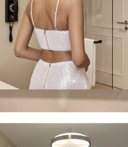 Close-up of the back metal zipper closure on the sequined crop top and skirt set