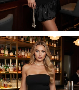 Détail d'un ensemble élégant de perles blanches porté sur une robe de cocktail noire