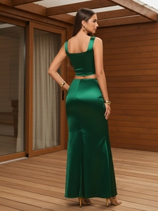 Dark green satin two-piece set featuring a backless crop top and high waist slit skirt