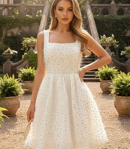 Detail of white sequin cocktail dress with fuzzy texture and sparkling silver embellishments