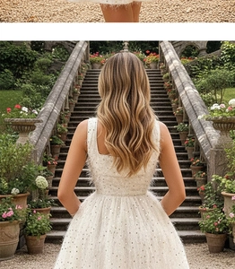 Rear view of white sequin dress with feather texture in a classical garden setting