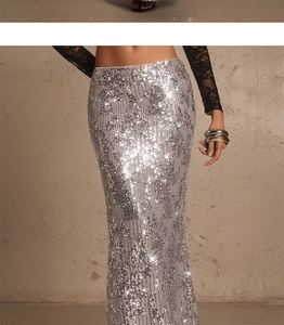 Detailed close-up of shiny silver sequins on high-waisted fishtail maxi party skirt