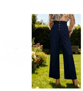 Detail of high waisted wide leg trousers with vertical button fly and drape effect