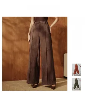 Detail showing high-waisted wide-leg trousers in dark brown with vertical corduroy texture