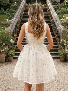 Sparkly white sequin party dress with feather tassels and sleeveless A-line silhouette
