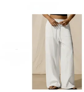 Detailed macro view of white linen texture and drawstring waist on wide-leg casual pants
