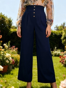 High waist navy blue wide leg trousers with vintage button details in garden setting