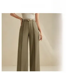 Detail of high waist olive wide leg trousers with dual pleats and decorative brown belt