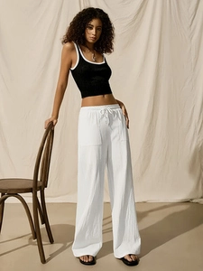Women's summer two-piece set featuring black crop tank top and white drawstring trousers