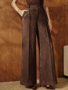 High-waisted dark brown suede wide-leg trousers with central pleats and loose fit