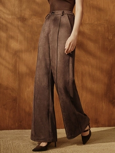 High-waisted dark brown suede wide-leg trousers with elegant drape and front pleats